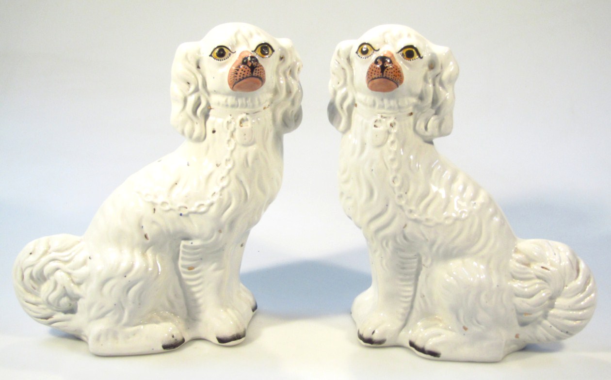 Appraisal: A pair of early thC Staffordshire flat back spaniels each