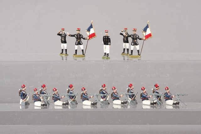 Appraisal: A similar lot of metal figures representing officers and machine