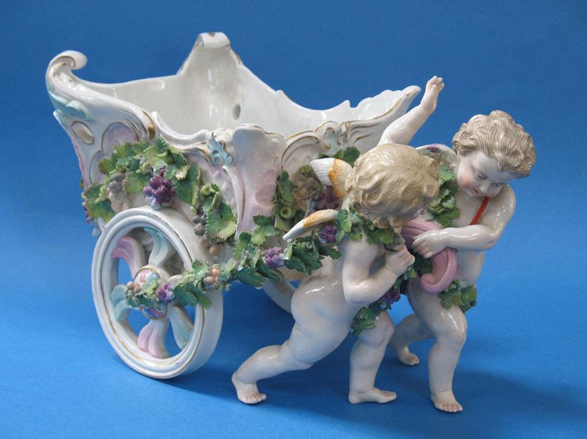 Appraisal: A DRESDEN STYLE COACH AND CHERUB TABLE CENTREPIECE modelled as