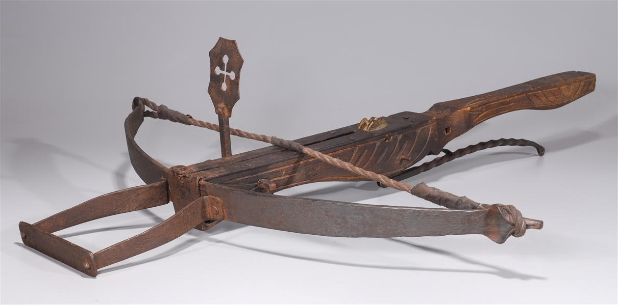 Appraisal: Wood and metal crossbow with unusual carving throughout flamboyant cross-shaped