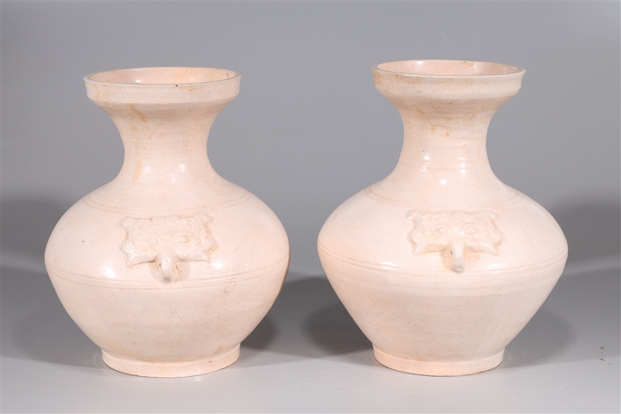 Appraisal: Pair of early style Chinese ceramic vases with molded mask