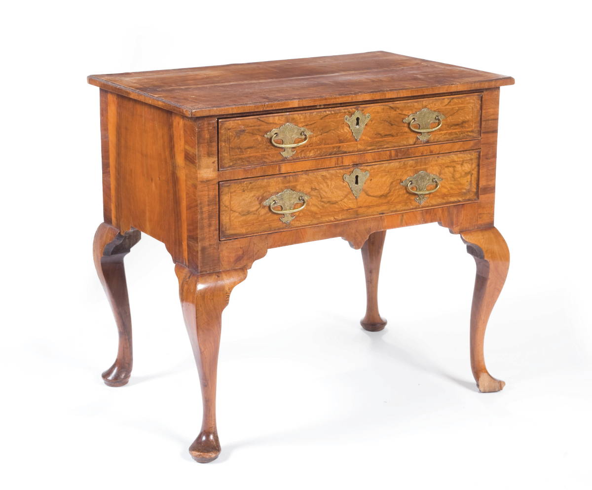 Appraisal: GEORGIAN VENEERED WALNUT AND MAHOGANY LOWBOY The rectangular top with