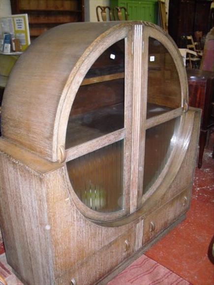 Appraisal: A limed oak dining suite in the Art Deco taste