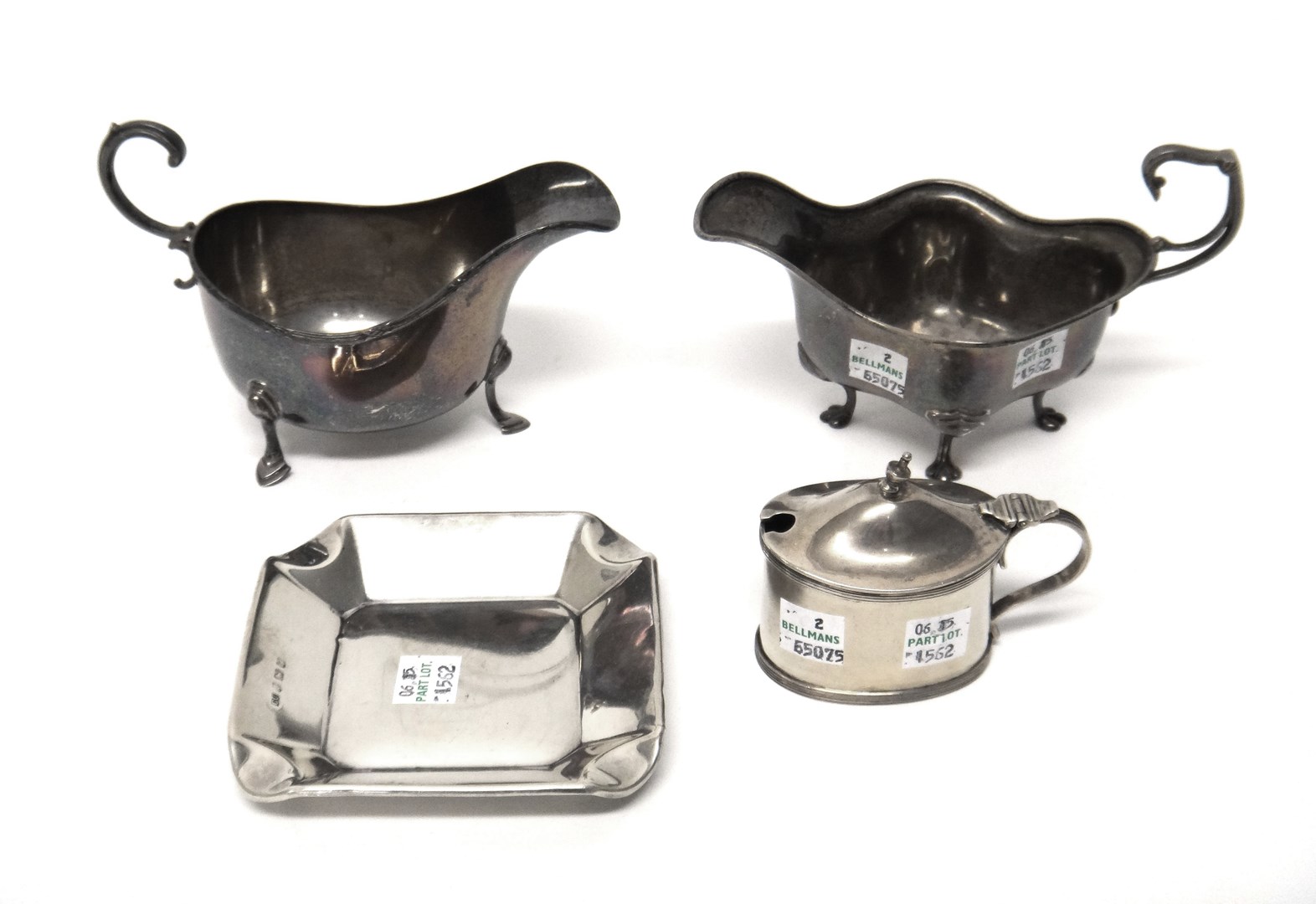 Appraisal: Silver comprising a sauceboat of shaped form raised on four