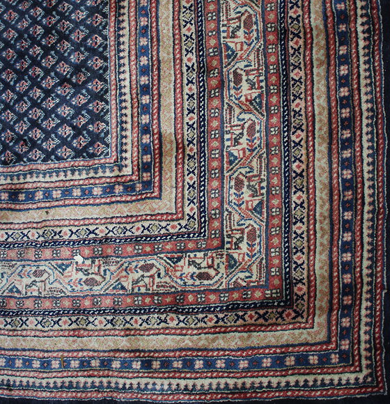 Appraisal: A LATE TH CENTURY BLUE GROUND RUG with multiple banded