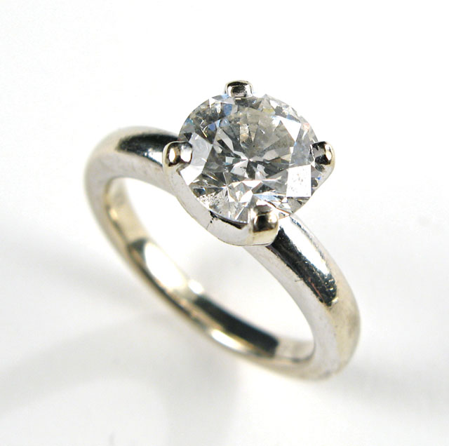 Appraisal: ESTATE DIAMOND AND FOURTEEN KARAT GOLD RING with appraisal Centered