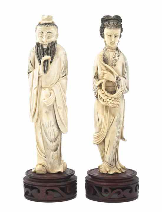 Appraisal: A Pair of Ivory Figures depicting a man holding his