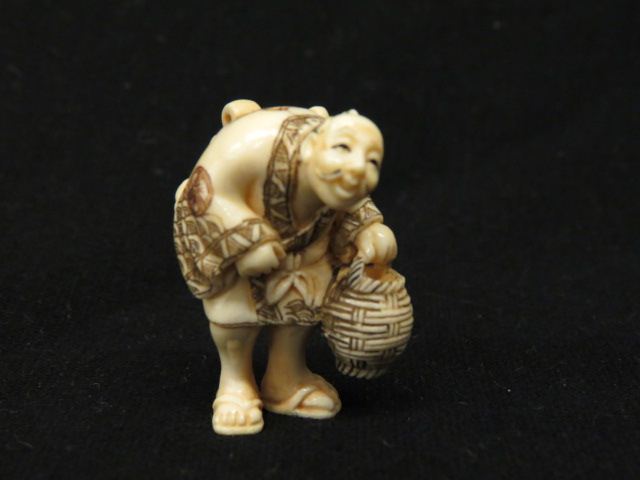 Appraisal: Carved Ivory Netsuke of an Old Man carrying a basket