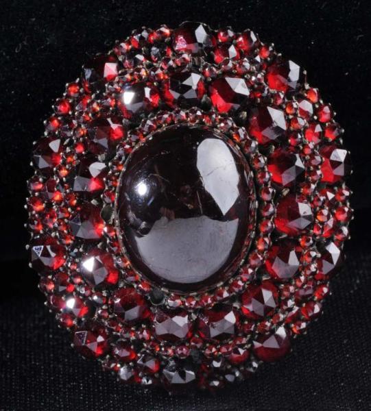 Appraisal: Victorian Garnet Pin Description Large center one-inch long garnet in