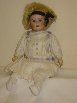 Appraisal: A Shoenau Hoffmeister bisque head girl doll with fixed blue