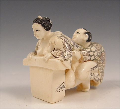 Appraisal: JAPANESE IVORY EROTICA OKIMONO Two figures measures '' h x