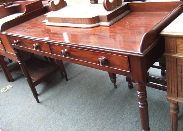 Appraisal: An early th century mahogany side table with gallery and