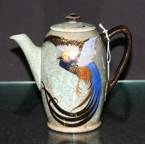 Appraisal: A Titanium ware coffee pot and cover decorated with a