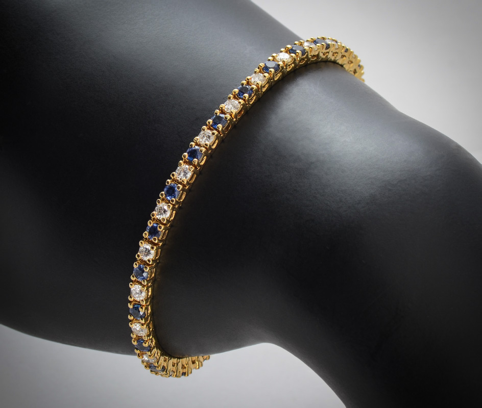 Appraisal: K DIAMOND AND SAPPHIRE TENNIS BRACELET K yellow gold bracelet