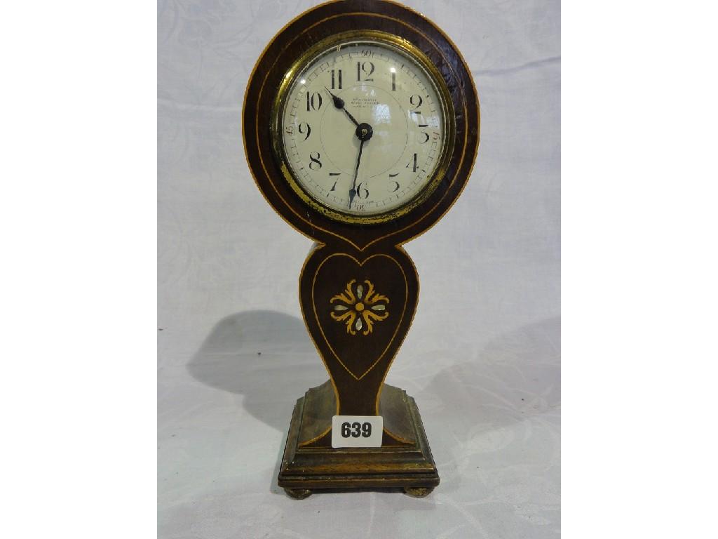 Appraisal: An inlaid Edwardian mahogany mantle clock in a balloon shaped