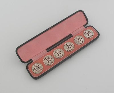 Appraisal: A cased set of six late Victorian pierced buttons by