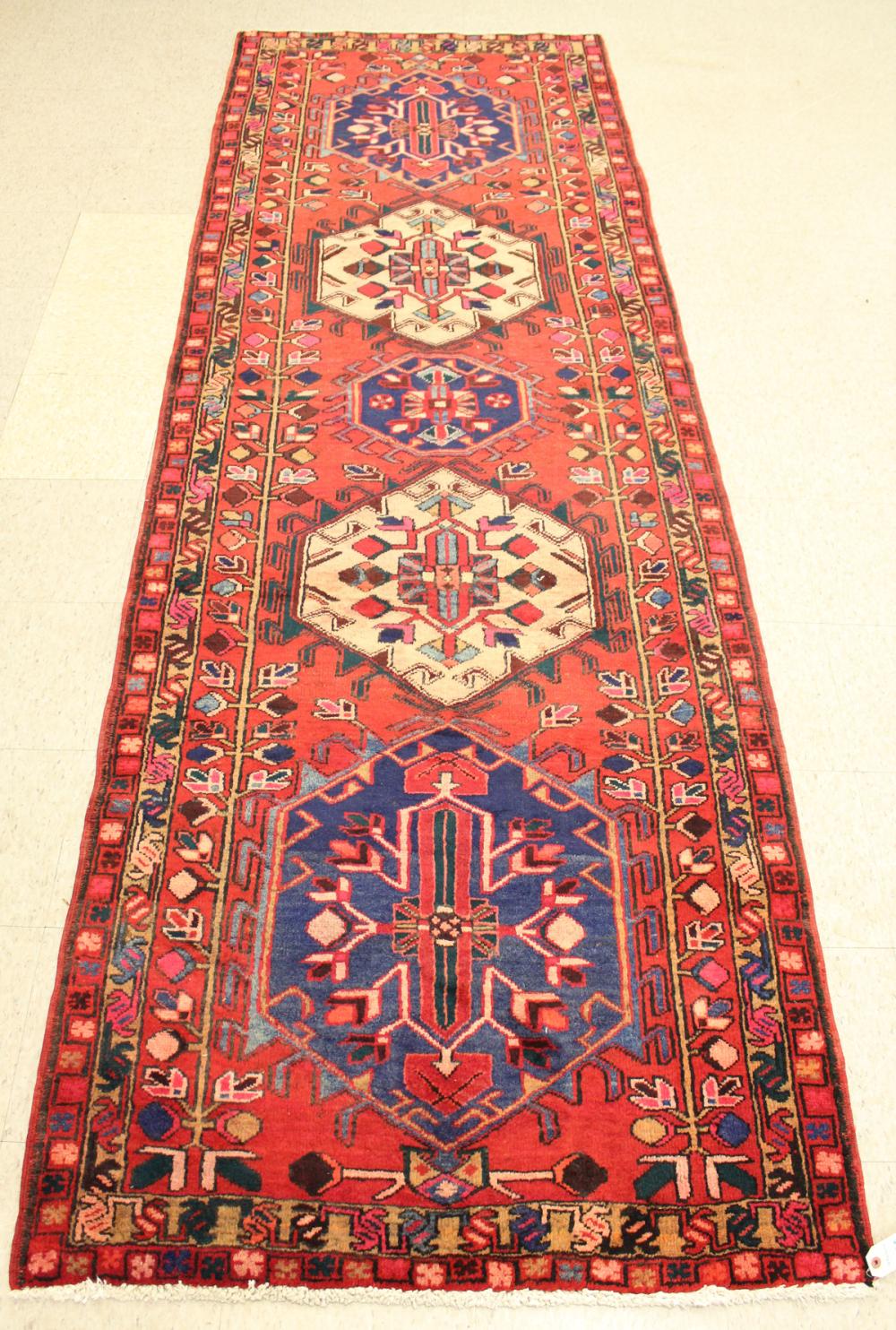 Appraisal: HAND KNOTTED PERSIAN TRIBAL AREA RUG featuring five hexagonal medallions