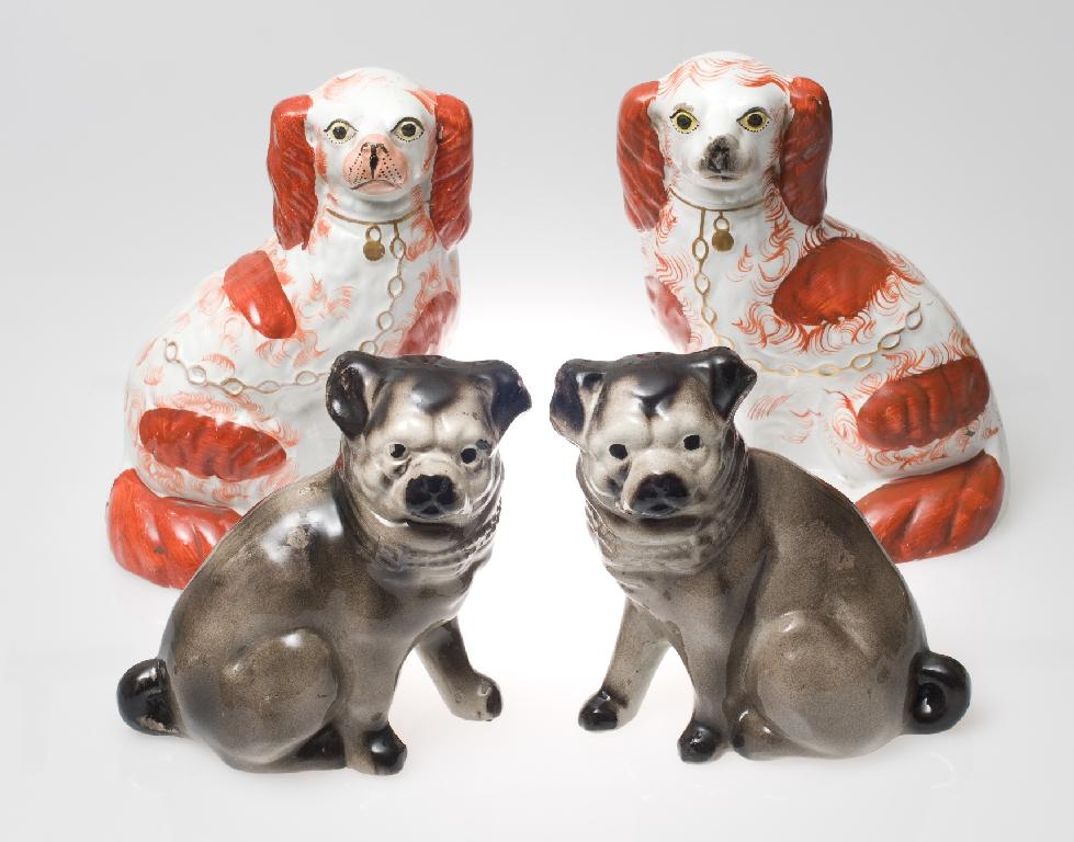 Appraisal: PAIR OF th CENTURY STAFFORDSHIRE MODELS OF SEATED RED AND