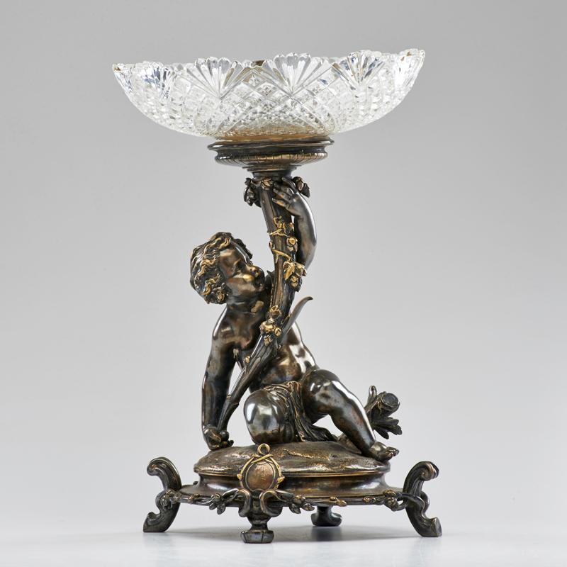 Appraisal: CHRISTOFLE Figural centerpiece of putto holding a torch France early