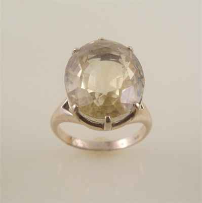 Appraisal: A yellow sapphire ring the large oval mixed cut stone