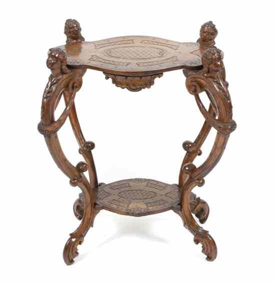 Appraisal: A Baroque Style Carved Walnut Occasional Table having an incised