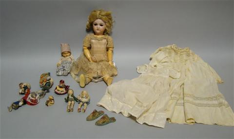 Appraisal: A GERMAN DOLL WITH OTHER SMALL DOLLS Her hair in