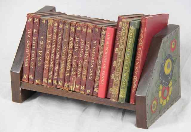 Appraisal: An Arts Crafts bookstand the ends embossed and painted with