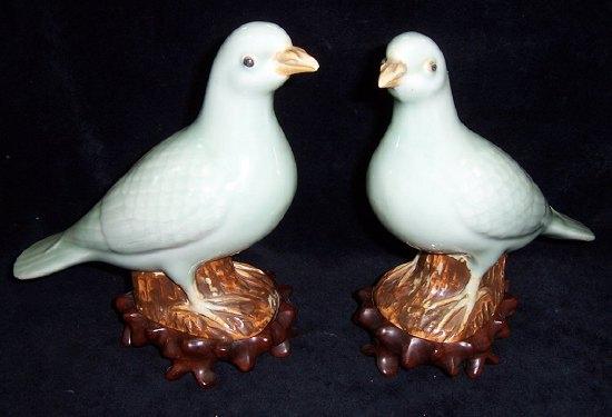 Appraisal: A pair of Oriental celadon doves each on a tree