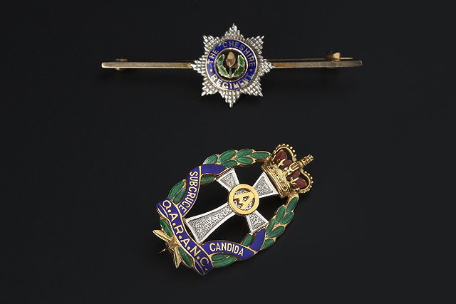 Appraisal: TWO ENAMEL REGIMENTAL BROOCHES BY GARRARD CO LTD the first