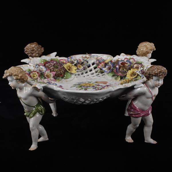 Appraisal: Von Schierholz German porcelain center bowl with putti figural supports