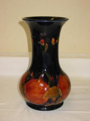 Appraisal: A MOORCROFT POMEGRANATE PATTERN VASE of baluster form in typical