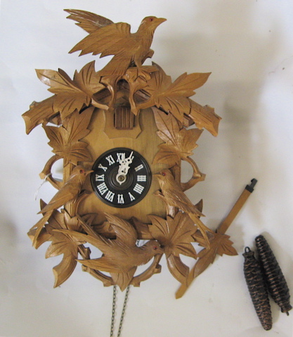 Appraisal: TWO GERMAN CARVED CUCKOO CLOCKS the larger with dark walnut