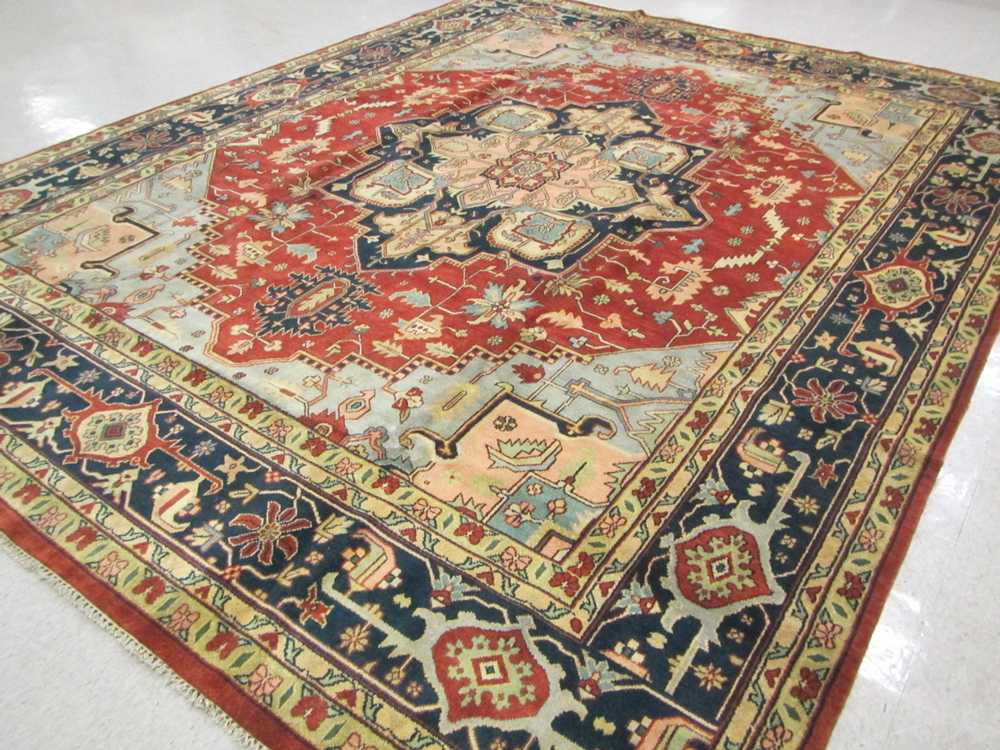 Appraisal: HAND KNOTTED ORIENTAL CARPET Persian Serapi design central geometric medallion