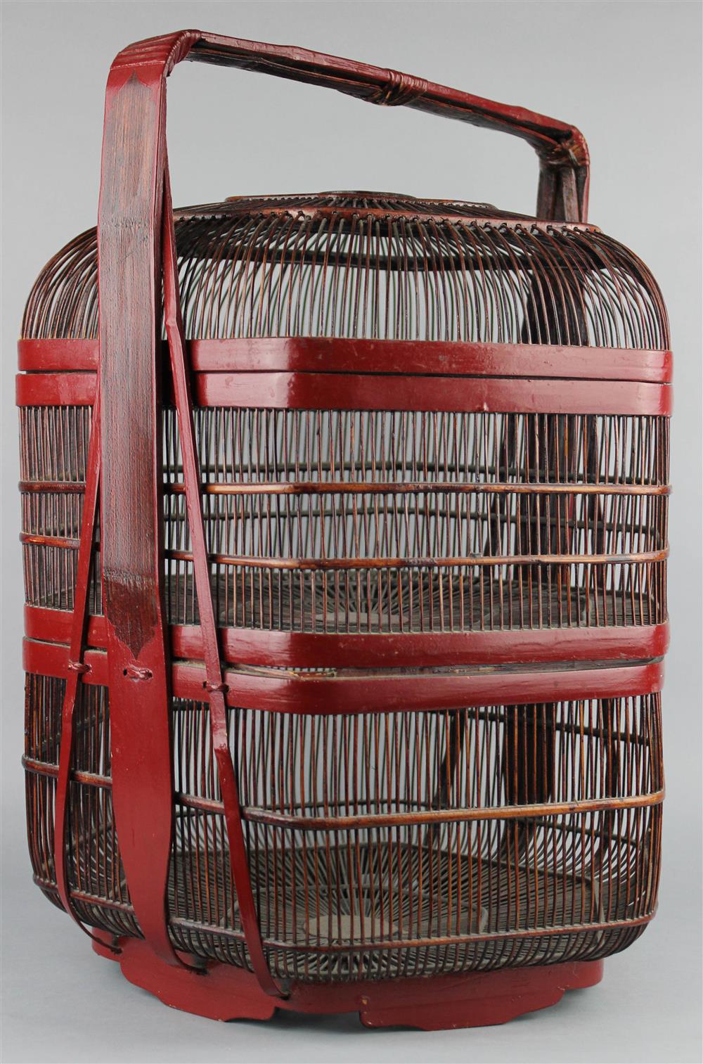 Appraisal: JAPANESE RED STAINED TWO-TIER BASKET with a wide handle above