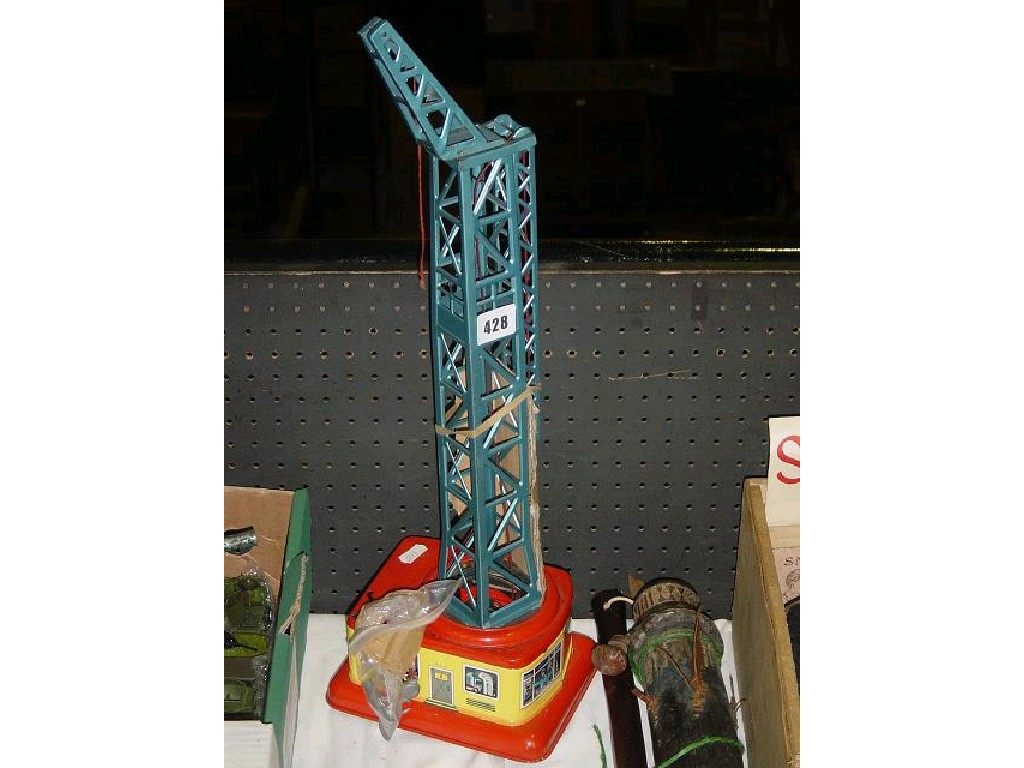 Appraisal: A tin plate and clockwork tower crane together with a