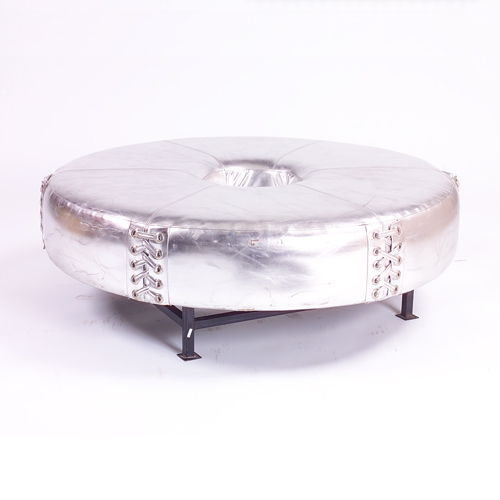 Appraisal: Thiery Mugler silver leather donut ottoman with laced sides on