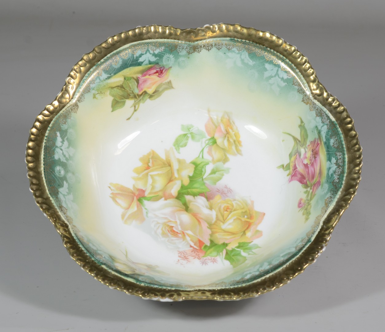 Appraisal: RS Prussia porcelain green and gold bowl decorated with roses