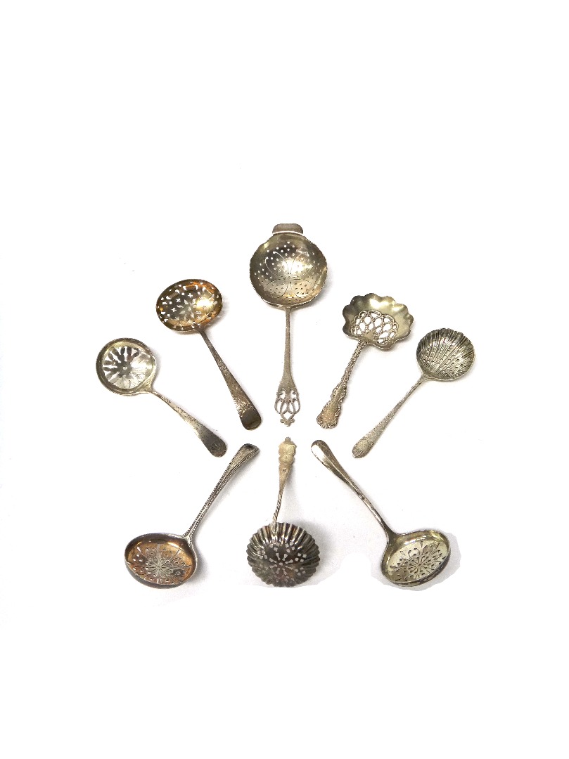 Appraisal: A silver tea strainer the handle with pierced decoration Sheffield