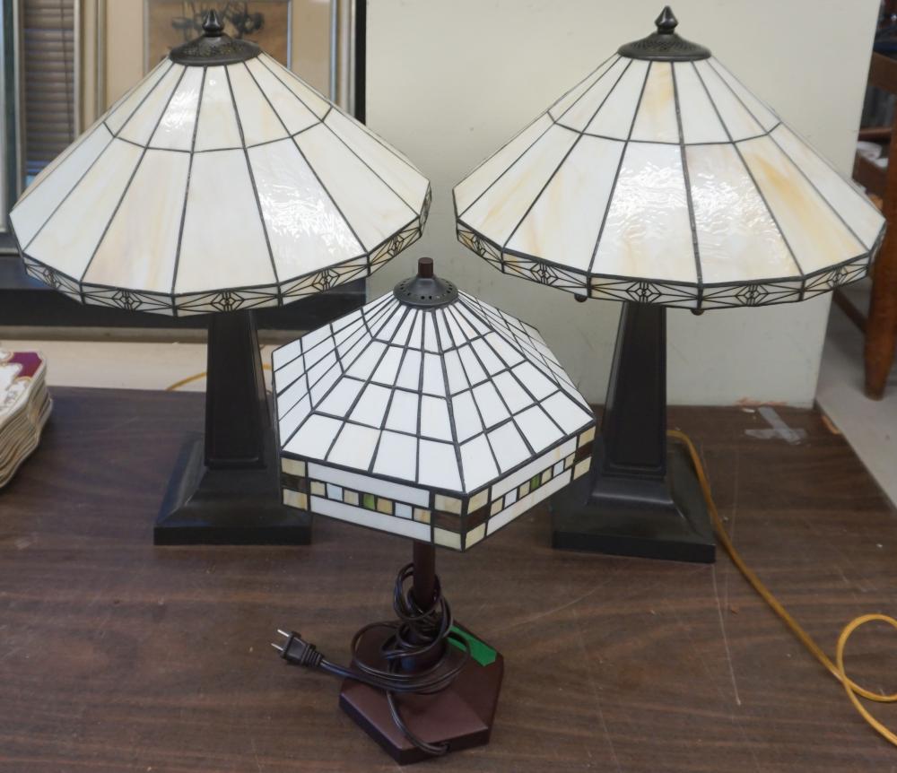 Appraisal: THREE CONTEMPORARY PATINATED METAL TABLE LAMPS WITH LEADED GLASS SHADES