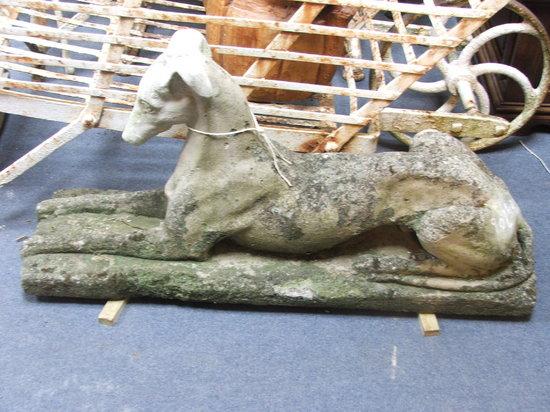 Appraisal: A WEATHERED COMPOSITION MODEL OF A SEATED GREYHOUND on a