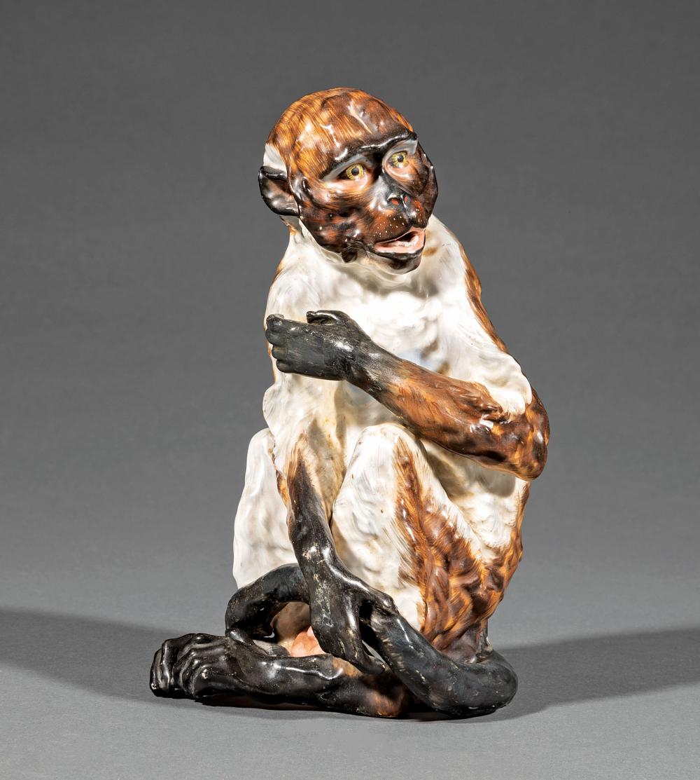 Appraisal: German Porcelain Figure of a Seated Monkey crossed lines mark