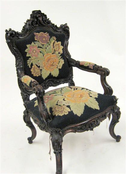 Appraisal: Rococo style mahogany armchair Elaborately carved throughout with shells and