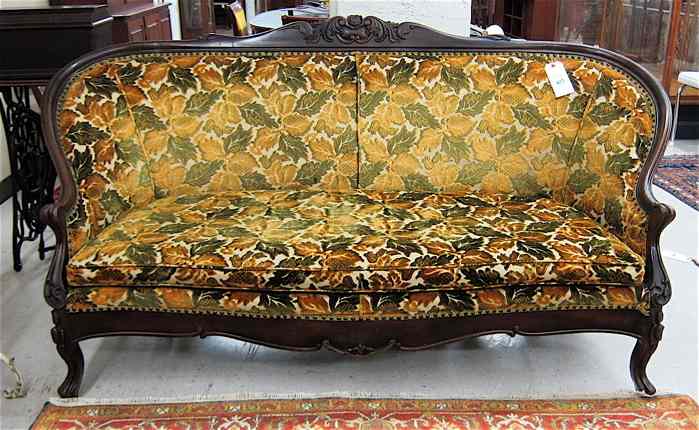 Appraisal: VICTORIAN-STYLE MAHOGANY SOFA American early th century having a carved