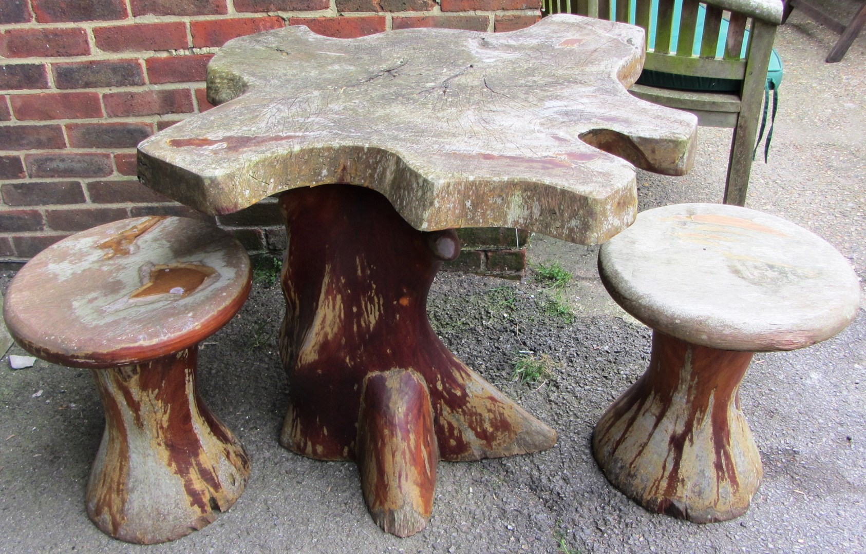 Appraisal: A th century hardwood garden table of naturalistic form cm