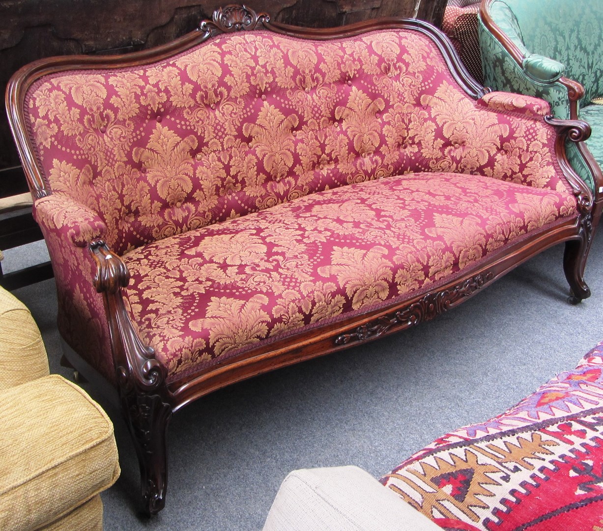 Appraisal: A Victorian rosewood framed sofa with shell carved crest semi