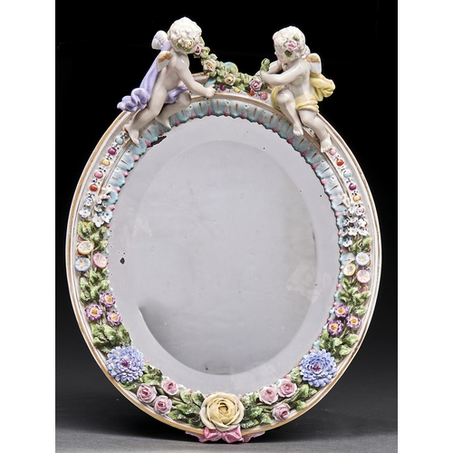 Appraisal: A German oval floral encrusted dressing mirror early th c