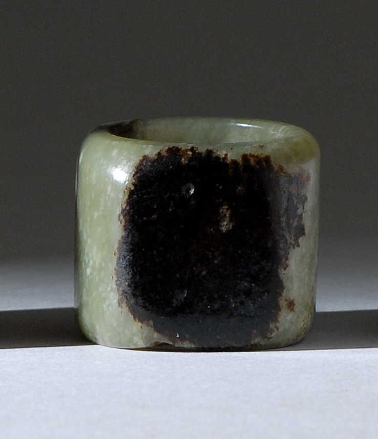 Appraisal: GREEN AND BLACK JADE ARCHER'S RING th CenturyWith flattened black