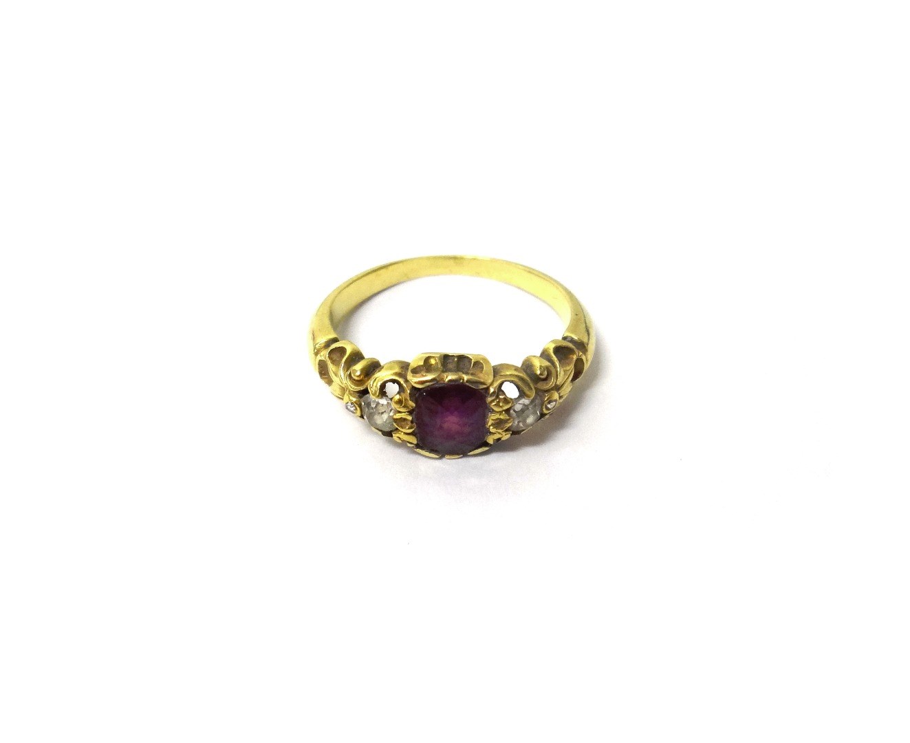 Appraisal: A gold ruby and diamond set three stone ring mounted