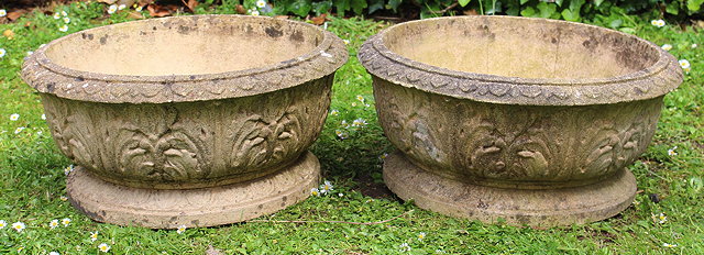 Appraisal: A PAIR OF RECONSTITUTED STONE CIRCULAR SHALLOW PLANTERS with moulded