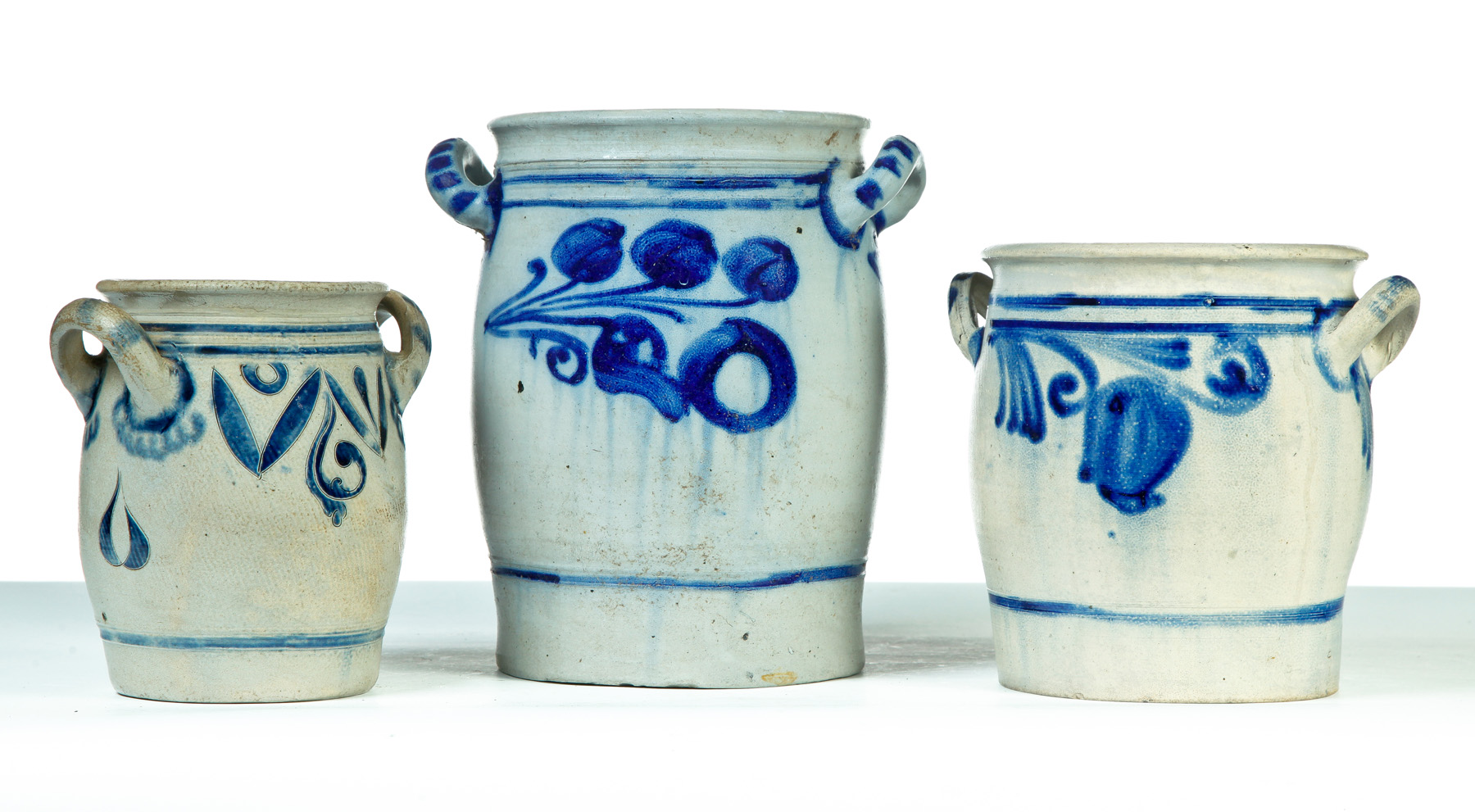 Appraisal: THREE GERMAN GRADUATED DOUBLE-HANDLED STONEWARE JARS Nineteenth century Salt glaze